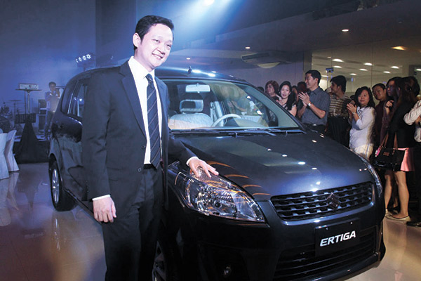 LOOKING SLEEK. Autocentral Group leader Brian Chua with the all-new Suzuki Ertiga. The seven-seater, compact multi-purpose vehicle Ertiga combines the maneuverability and agility of a compact car with the spacious interiors of an MPV.