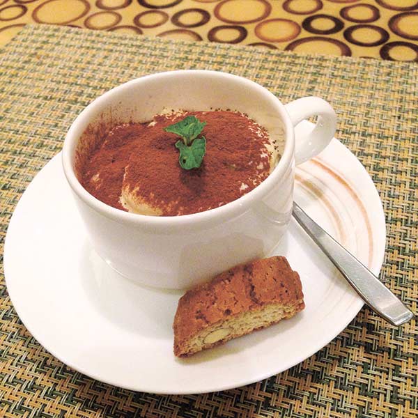 A classic dessert of Italian cuisine, the tiramisu. Layers of coffee-soaked ladyfingers topped with mascarpone mousse. 