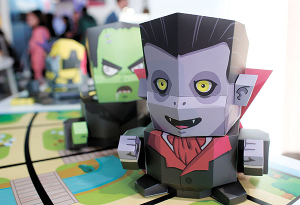PROGRAMMED SKINS. Interactive paper toys fitted onto a robot that is controlled by an app to help children learn programming are displayed during last week’s Mobile World Congress wireless show in Barcelona, Spain. Aimed at children as young as eight years old, the Kamibot robot can be covered with paper-made “skins” to turn it into a variety of characters, including Dracula, Frankenstein, and several popular figures in Korea. (AP PHOTO)