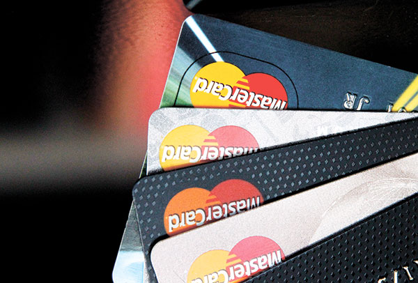 TO SWIPE OR NOT. Credit cards: friend or foe? (AP PHOTO)